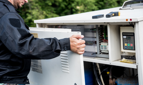An HVAC unit getting it's side panel put back on.